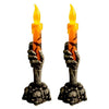 Halloween candle held by a skeleton hand on a skull base